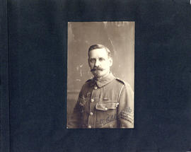 Portrait of uniformed soldier William A. Alldritt on a scrapbook page