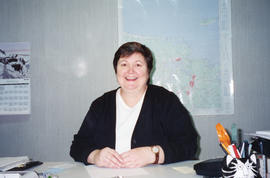 Photograph of Jo-Ann Riggs at her desk in the Administration Office of the Killam Memorial Library