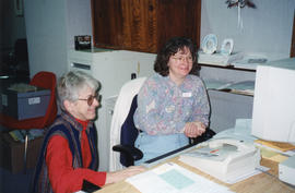 Photograph of Elaine Boychuk and Janice Slauenwhite in the Administration Office of the Killam Me...