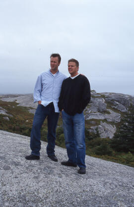 Photograph of two unidentified people standing on a rocky South Shore headland