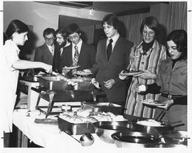 Photograph of guests lined up at a buffet