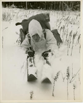 Photograph of an unidentified soldier, with skis, conducting winter infantry training at Debert