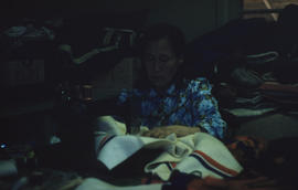 Photograph of an unidentified woman using a sewing machine