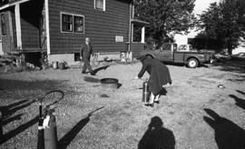 Photograph of two people testing fire extinguishers