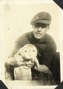 Photograph of the cable-ship Mackay-Bennett's lifeboat man Don Johnson holding a baby seal on Sab...