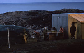 Photograph of several people and a freezer in George River, Quebec