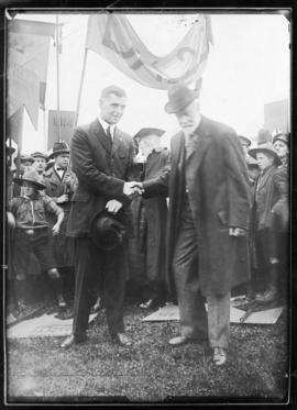 Photograph of Dr. K.A. Allison handing over the dedication tablets from the old college to Studen...