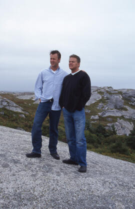 Photograph of two unidentified people standing on a rocky South Shore headland