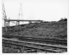 Photograph of train tracks and the MacKay Bridge on-ramp under construction