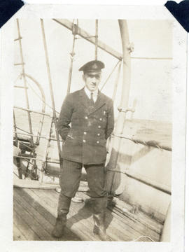 Photograph of navigating officer Fleming on the deck of the cable-ship Mackay-Bennett at sea
