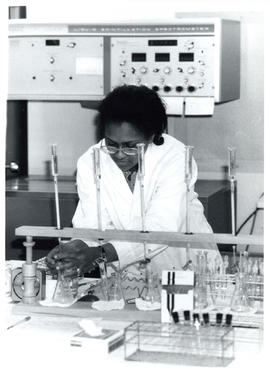 Photograph of individual working with flasks
