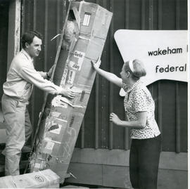 Photograph of Doreen and Collingwood Wynne moving a box at Wakeham Bay, Quebec