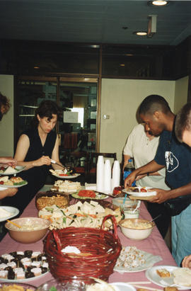 Photograph of people at the buffet table at a group staff baby shower held in the Killam Memorial...