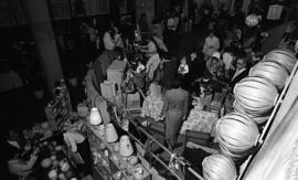 Photograph of stands and shoppers at a craft market