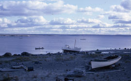 Photograph of several small boats on the shore or on the water in northern Quebec