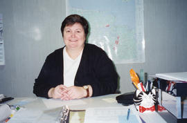 Photograph of Jo-Ann Riggs at her desk in the Administration Office of the Killam Memorial Library