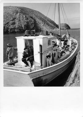 Photograph of Max Budgell on a boat in Port Burwell, Northwest Territories