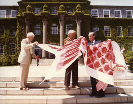 Photograph of Andrew MacKay and unidentified men holding a kite