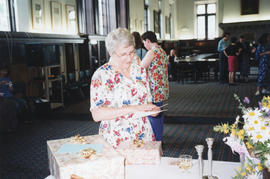 Photograph of Patricia Lutley reading a card at her retirement party