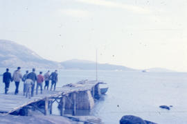 Photograph of a group of men on a dock in Davis Inlet, Newfoundland and Labrador