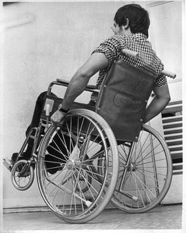 Photograph of Joe Robichaud balancing in a wheelchair