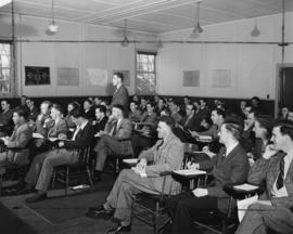Photograph of English professor Burns Martin teaching a classroom of veterans