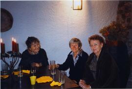 Photograph of Elisabeth Mann Borgese, at a table with two unidentified women