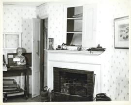 Photograph of a mantel in the Simeon Perkins house before its restoration, with a cupboard overhe...