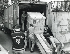 Photograph of men unloading a large crate at the Sir James Dunn Science Building