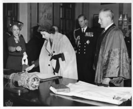Photograph of Princess Elizabeth signing a guest book in the Macdonald Memorial Library