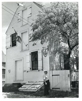 Photograph of H.B. Jefferson in front of the historic Ross-Thompson house and store in Shelburne,...