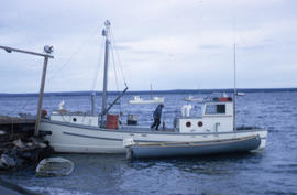 Photograph of a fishing boat and a canoe in northern Quebec