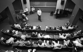 Photograph of an unidentified person giving a lecture to a music class