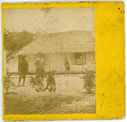 Photograph of unidentified Indigenous people standing in front of Rev. Thomas Nielson's mission h...