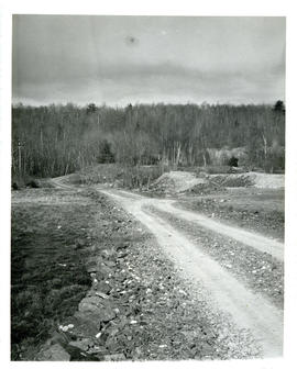 Photograph of a gravel road and tailings from the gold mine at Molega, Nova Scotia