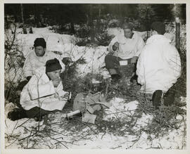 Photograph of four unidentified Canadian Seaforth Highlanders cooking during winter infantry trai...
