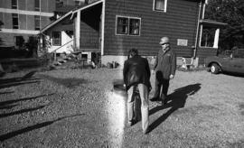 Photograph of two people testing fire extinguishers