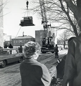 Photograph of a crane lifting a computer into the Sir James Dunn Science Building