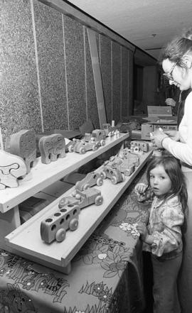 Photograph of a stand selling wooden toys at a craft market