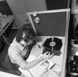 Photograph of a student listening to a record