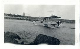 Photograph of a Navy hydroplane landing at Fort Point printed on a postcard