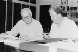 Photograph of Bill Birdsall, University Librarian, and an unidentified man looking at records in ...