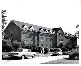 Photograph of Trueman House with landscaping and cars parked out front at the Nova Scotia Agricul...