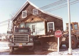 Photograph of the moving of a house off of the NSAC campus in 1982