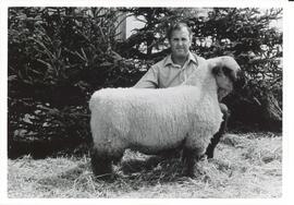 Photograph of Leo Jameison holding a sheep between 1960 and 1979