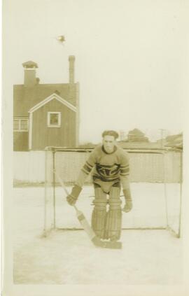 Photograph of Roy MacDonald in a Nova Scotia Agricultural College hockey goalie uniform on the ic...