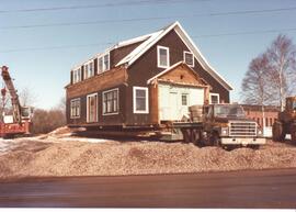 Photograph showing the moving of a house off of the NSAC campus in 1982