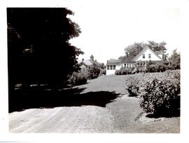 Photograph of the Nova Scotia Agricultural College's principal's house and Cumming Hall in the ba...