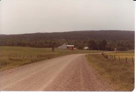Photograph of a building in the distance during the field day at Bill Mathewson's farm